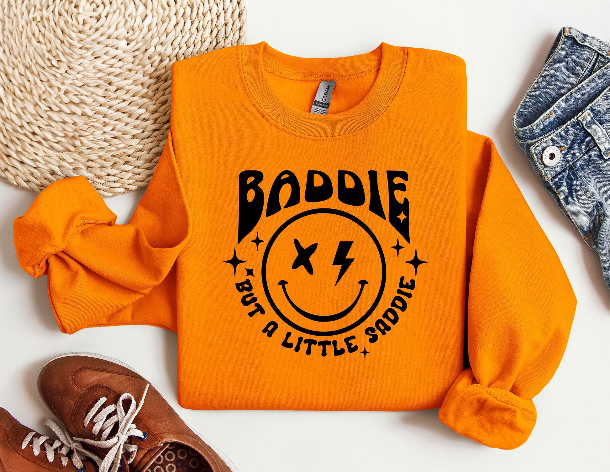 an orange sweatshirt with a smiley face on it