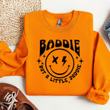 an orange sweatshirt with a smiley face on it