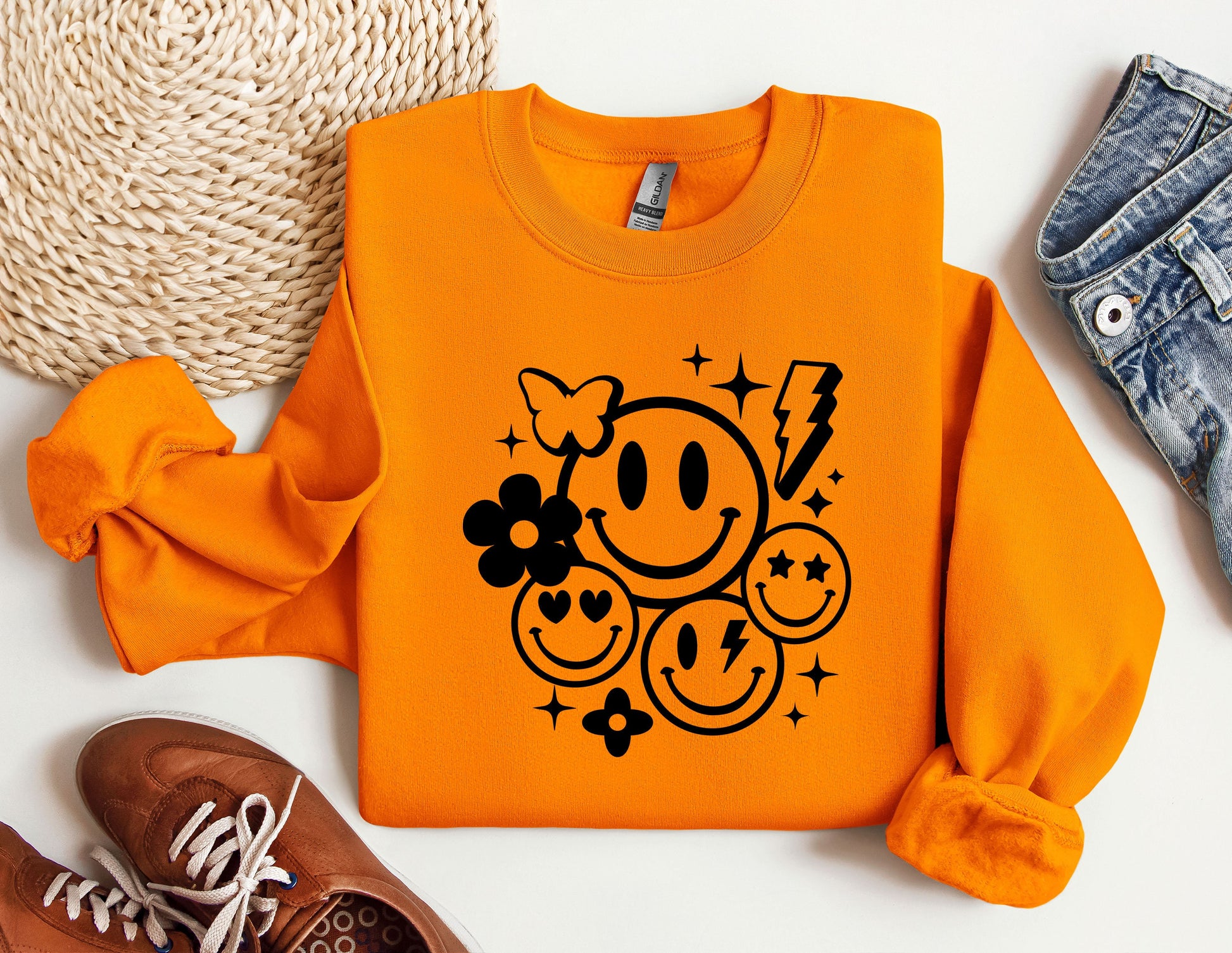 an orange sweater with a smiley face on it