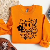 an orange sweater with a smiley face on it