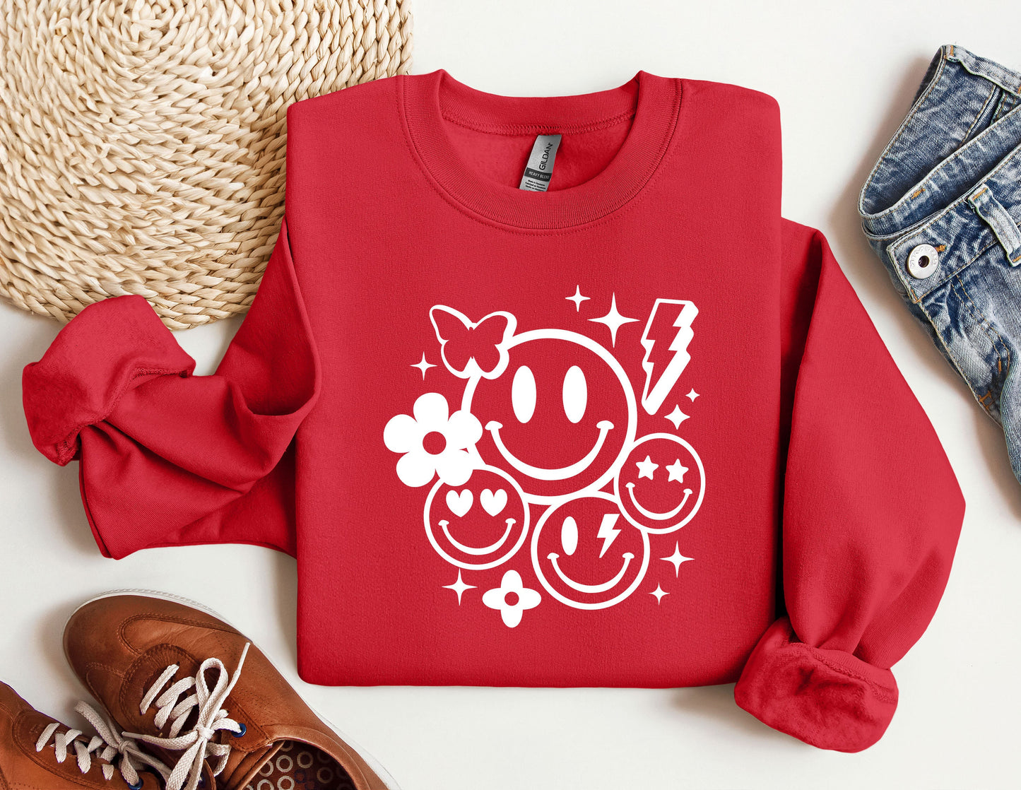 a red sweatshirt with a smiley face on it