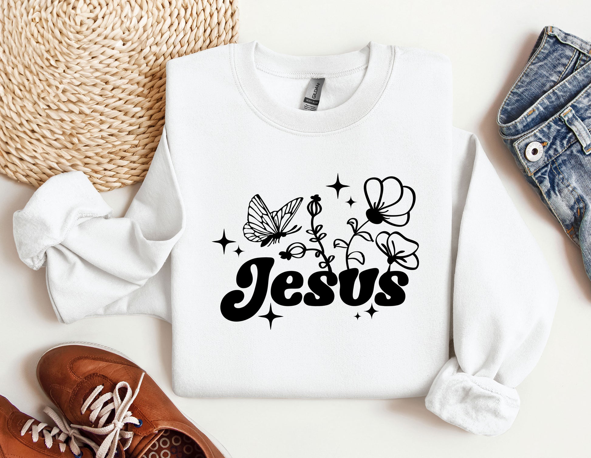 a white sweatshirt with the word jesus printed on it