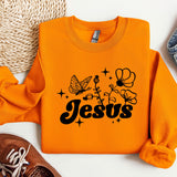 an orange sweatshirt with the word jesus printed on it