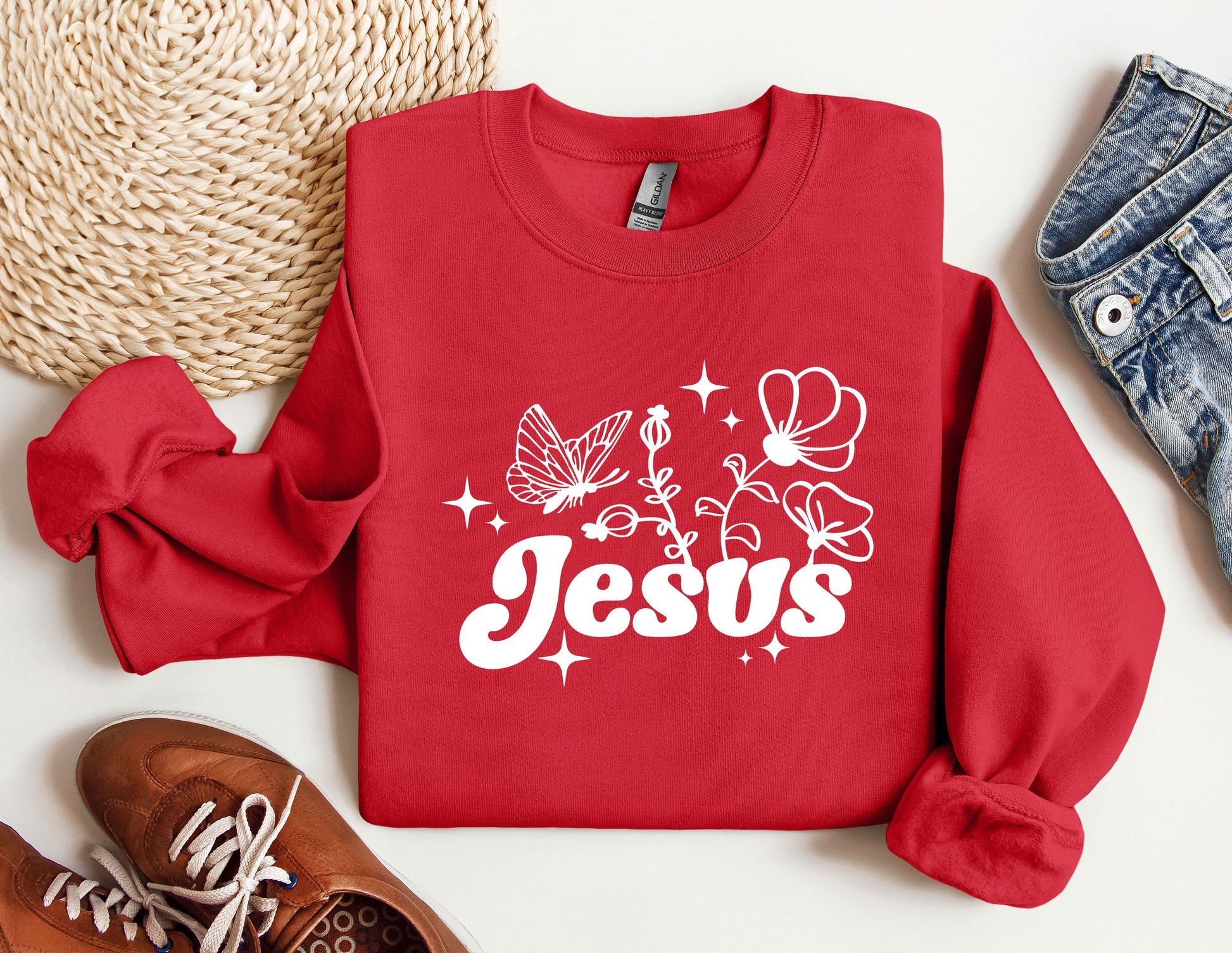 a red sweatshirt with the word jesus printed on it