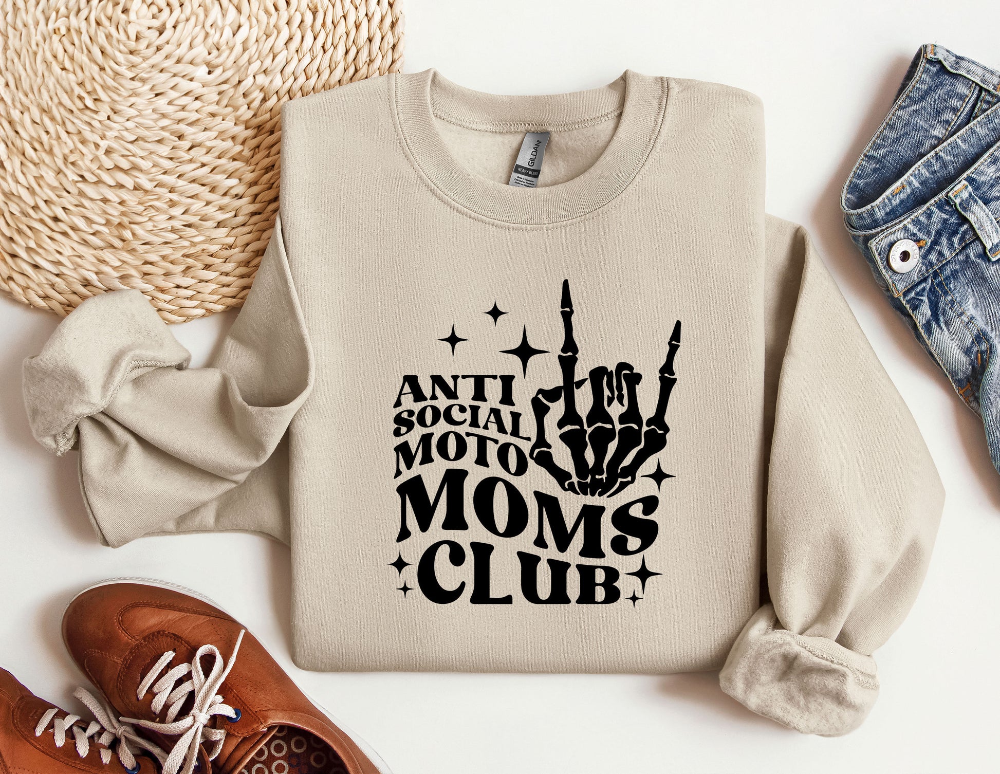 a sweatshirt with the words moms club on it next to a pair of shoes