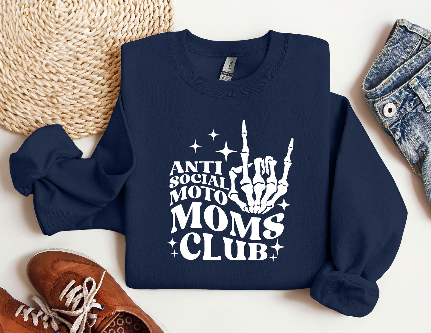 a sweatshirt that says anti social moms club next to a pair of sneakers