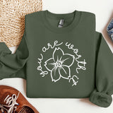 a green sweatshirt with a white flower on it