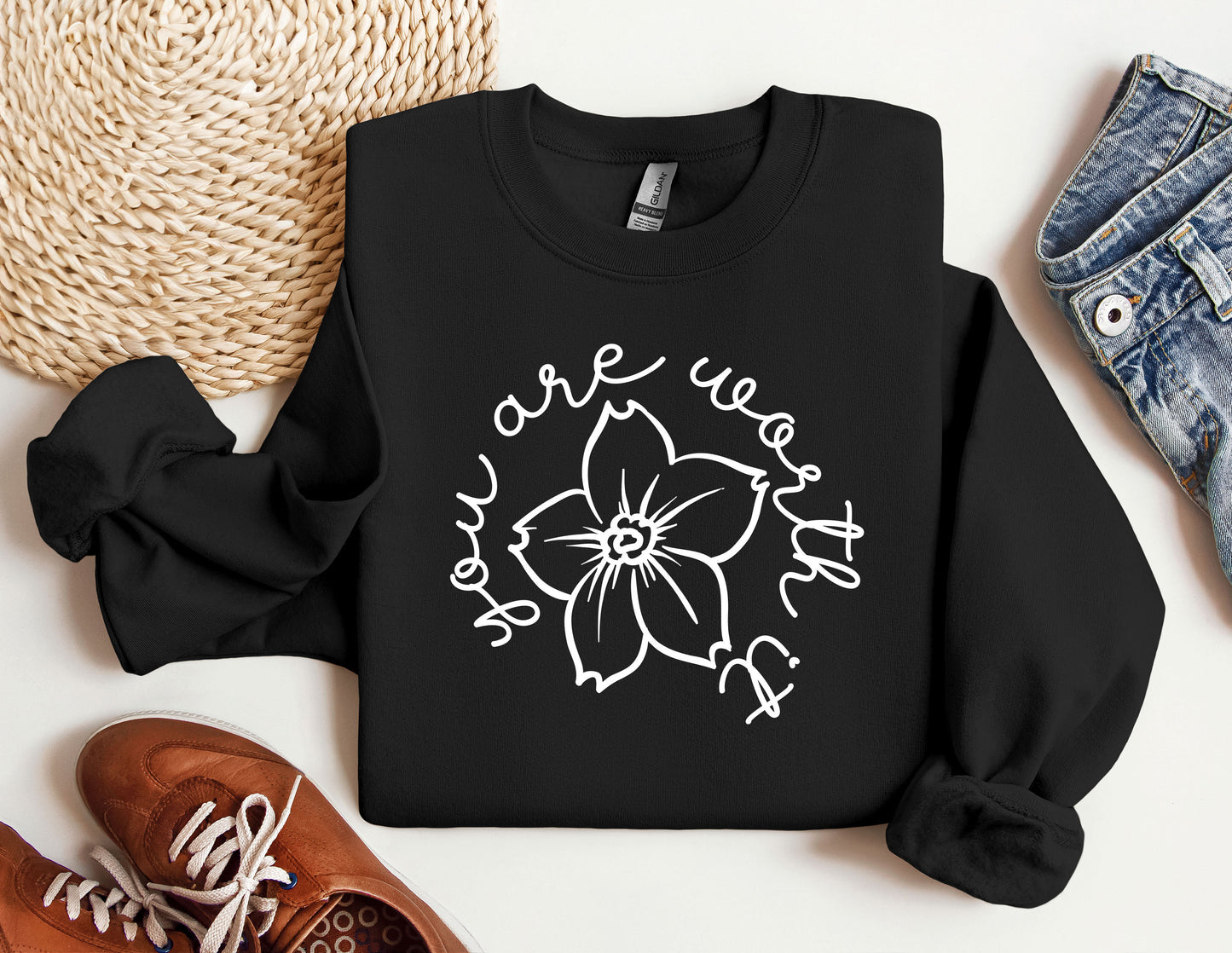 a black sweatshirt with a white flower on it