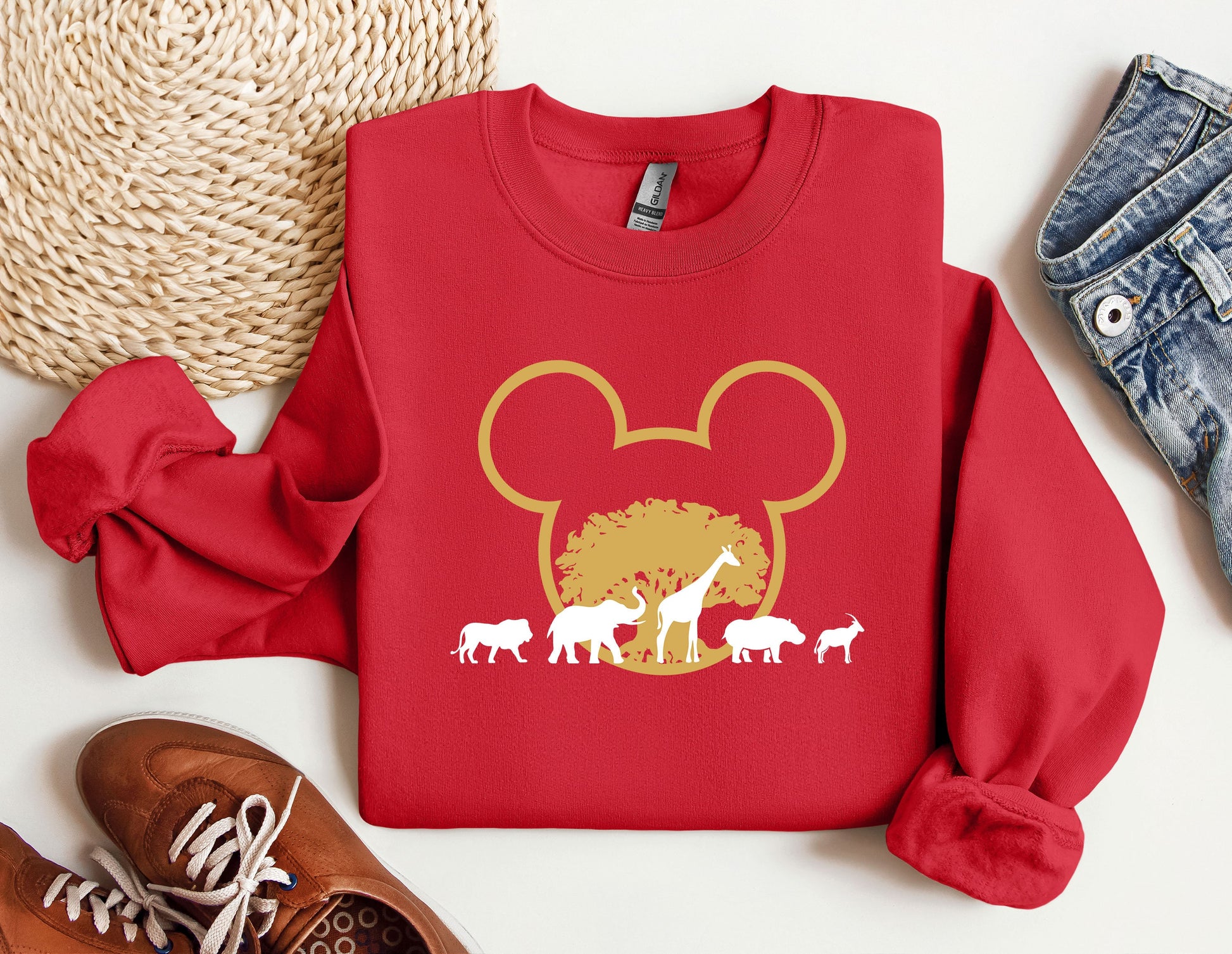 a red mickey mouse shirt with animals on it