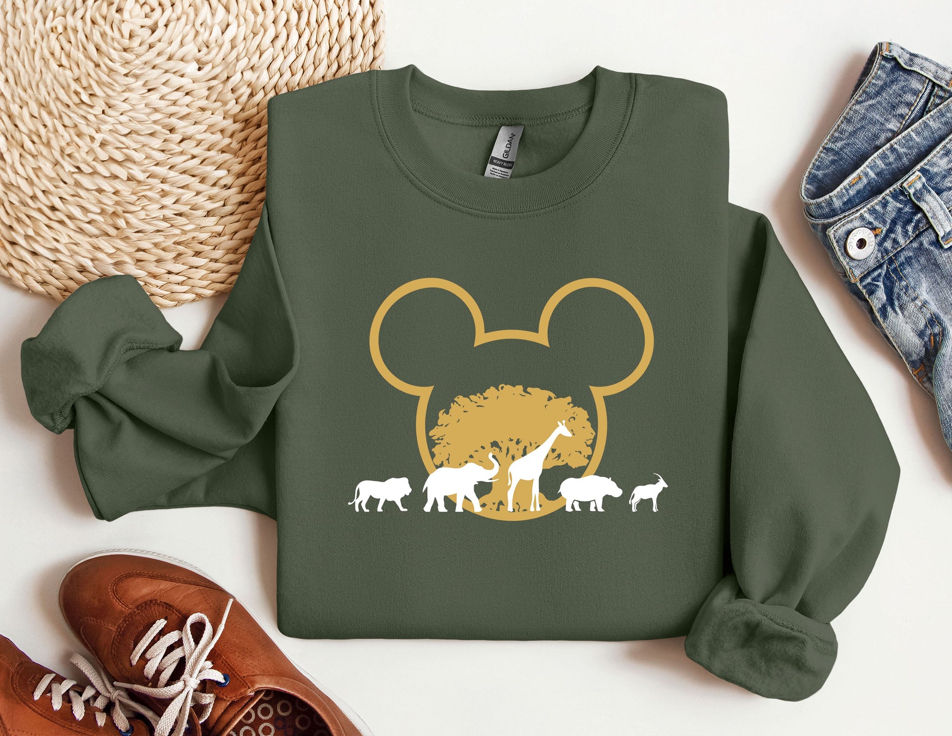 a green shirt with an image of a mouse and some animals