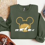 a green shirt with an image of a mouse and some animals