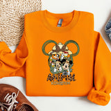 a pair of sneakers and an orange mickey mouse shirt