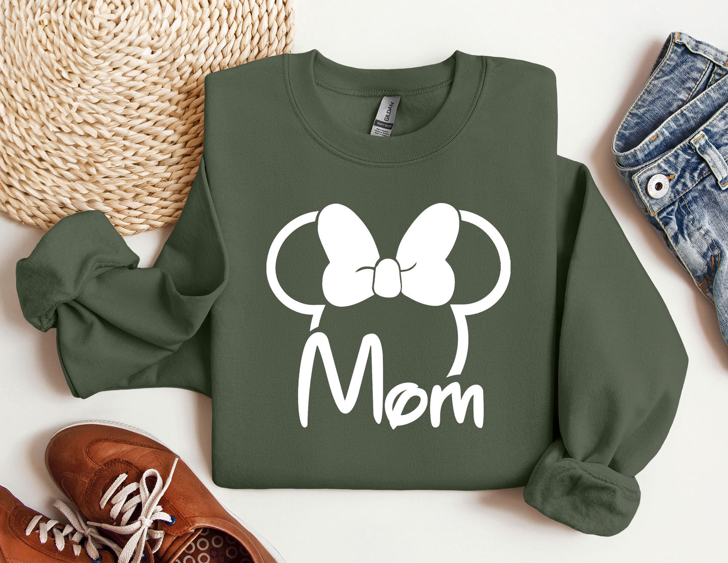 a green sweatshirt with a minnie mouse head on it