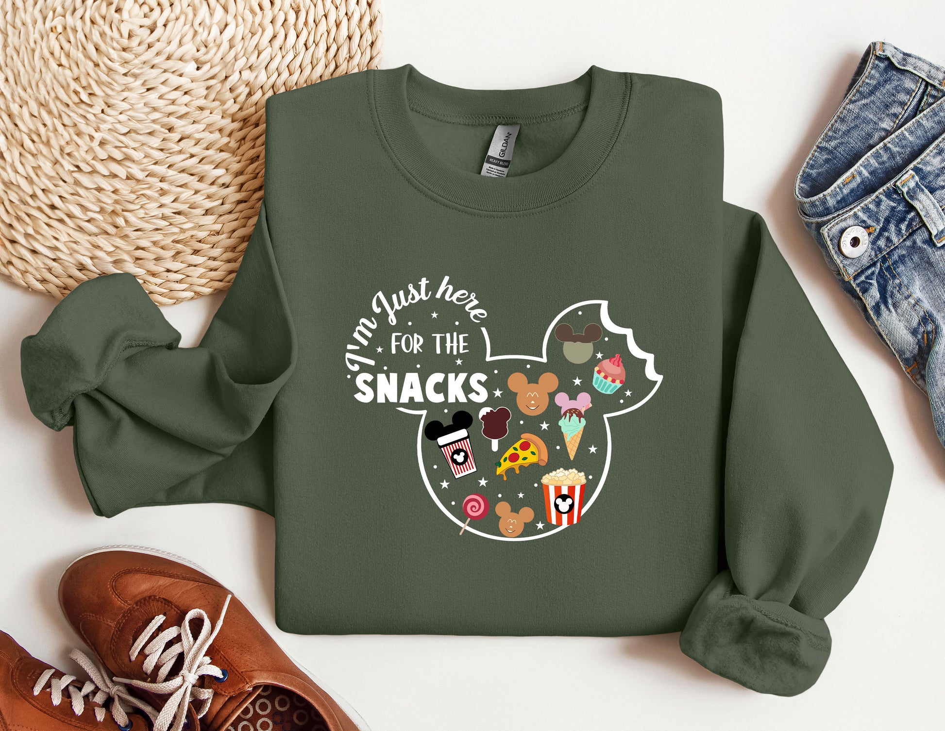 a green sweatshirt with a mickey mouse design