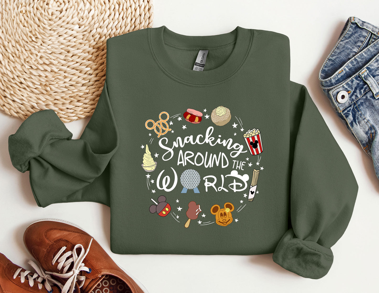 a green sweatshirt with mickey mouse and other items