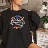 a woman sitting on a bed wearing a black shirt