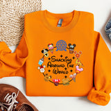 an orange shirt with mickey mouses around the world on it