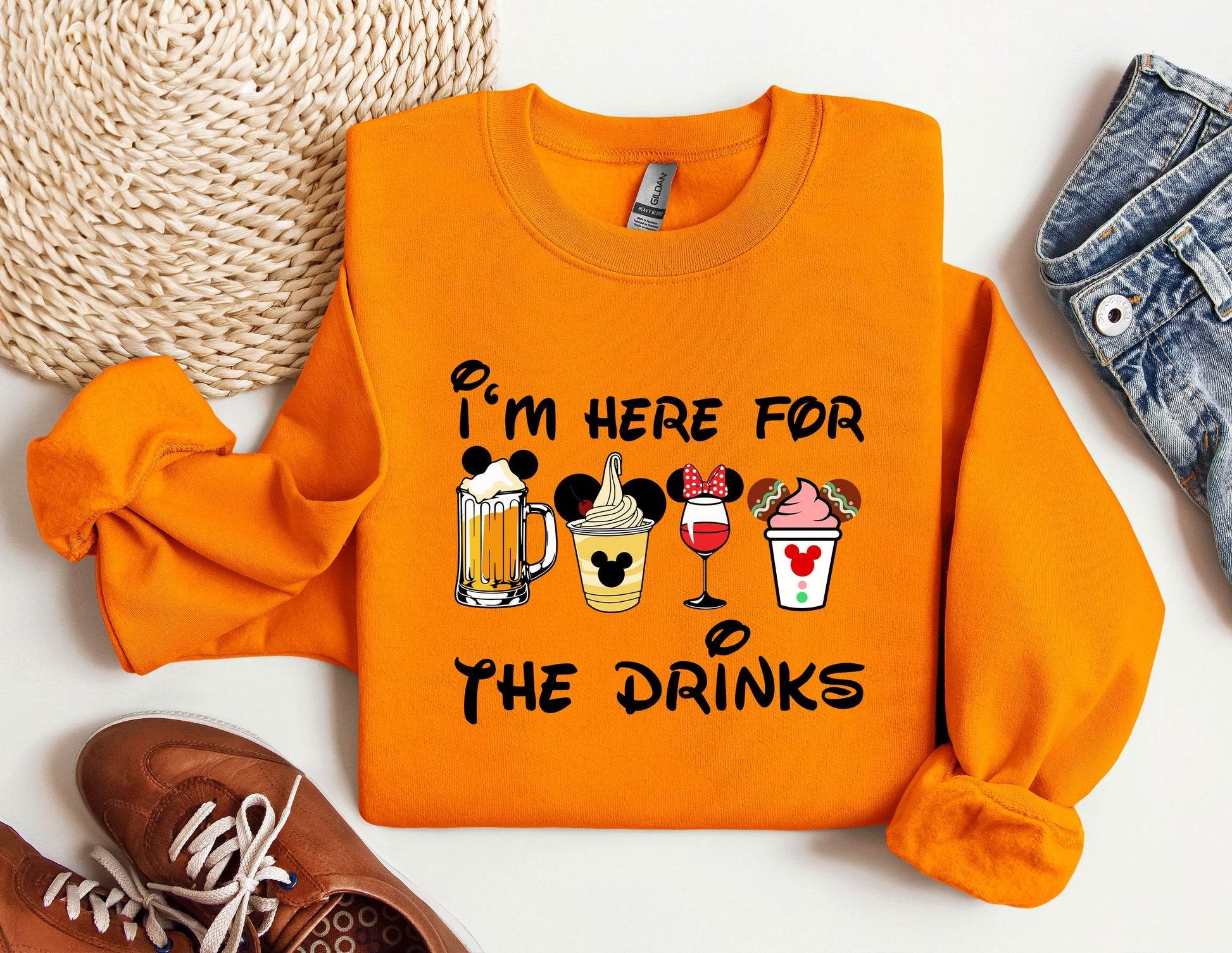 an orange sweatshirt with a mickey mouse design on it