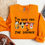 an orange sweatshirt with a mickey mouse design on it