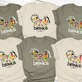 a group of mickey mouse shirts on a wooden surface