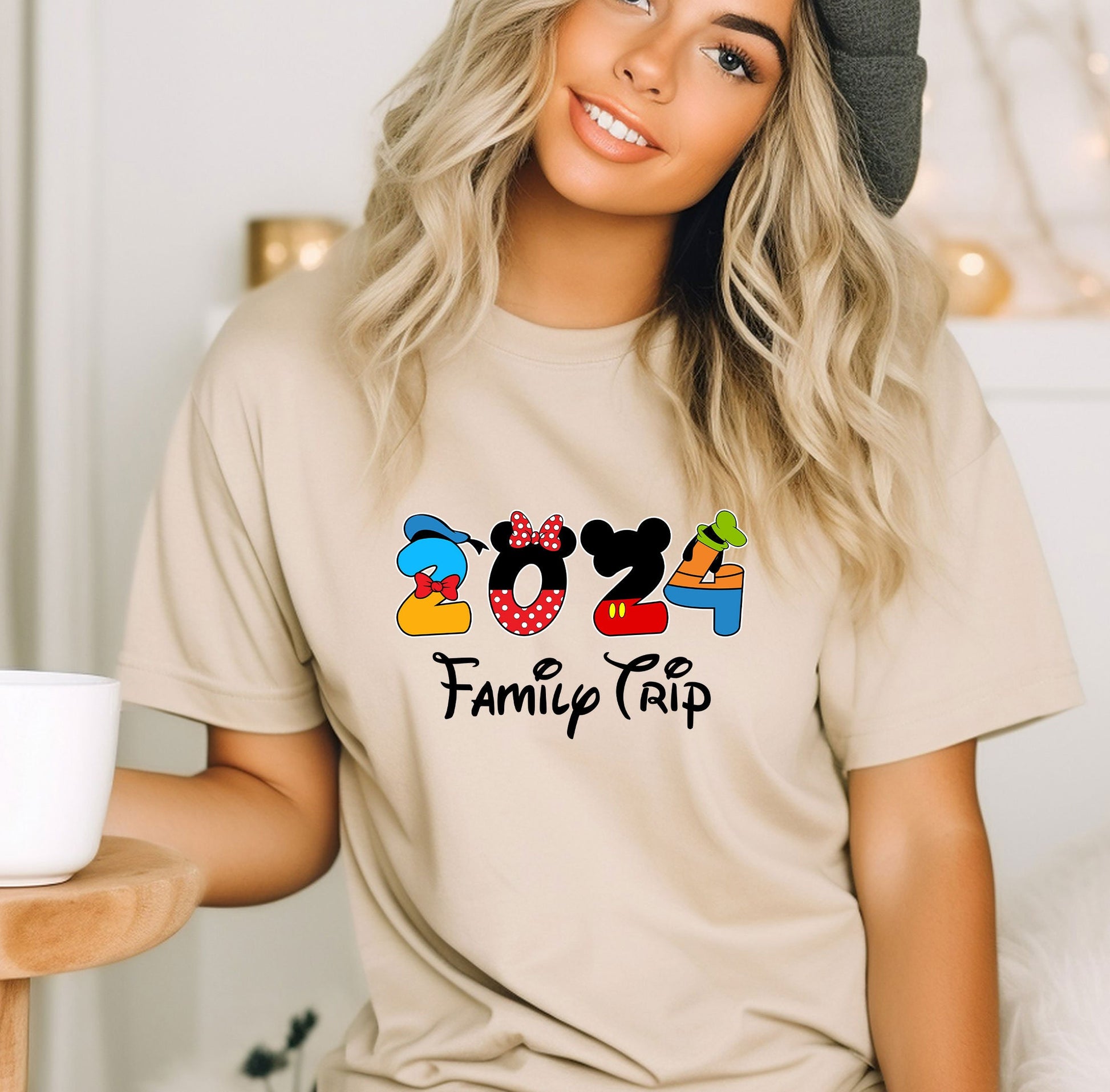 a woman wearing a mickey mouse family trip shirt