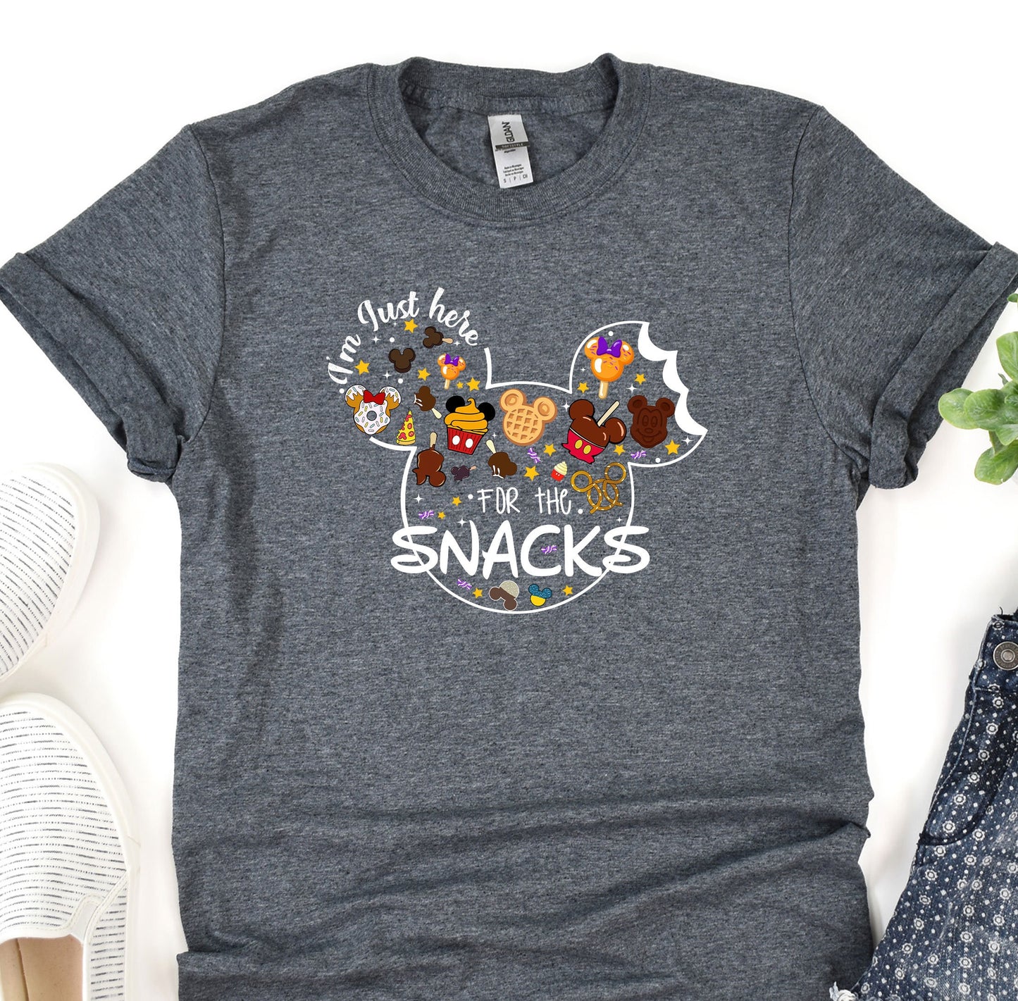 a mickey mouse t - shirt with the words snack for the snacks on it