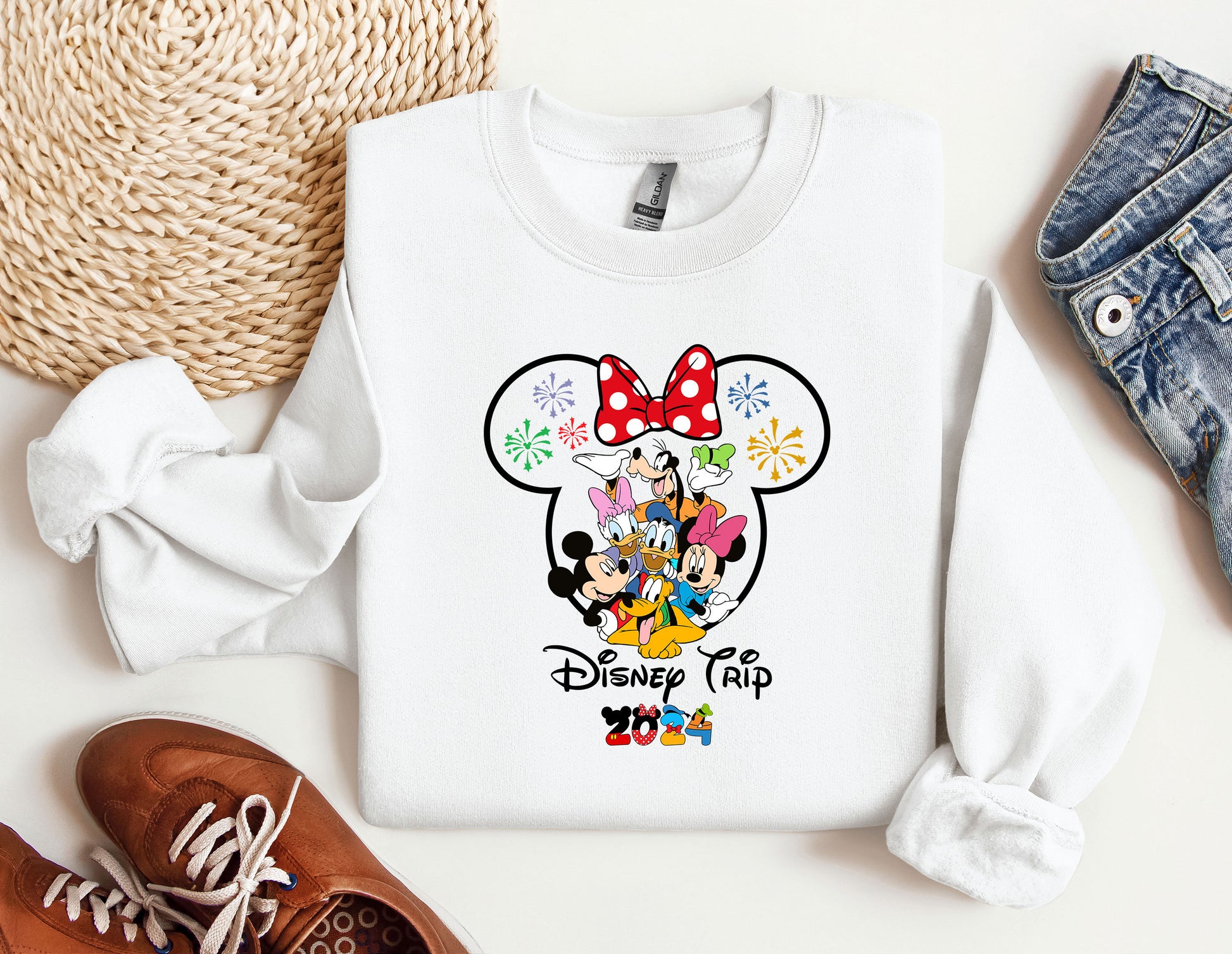 a mickey mouse shirt with a red bow on it