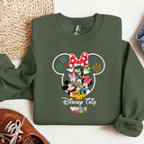 a green sweatshirt with mickey mouse on it