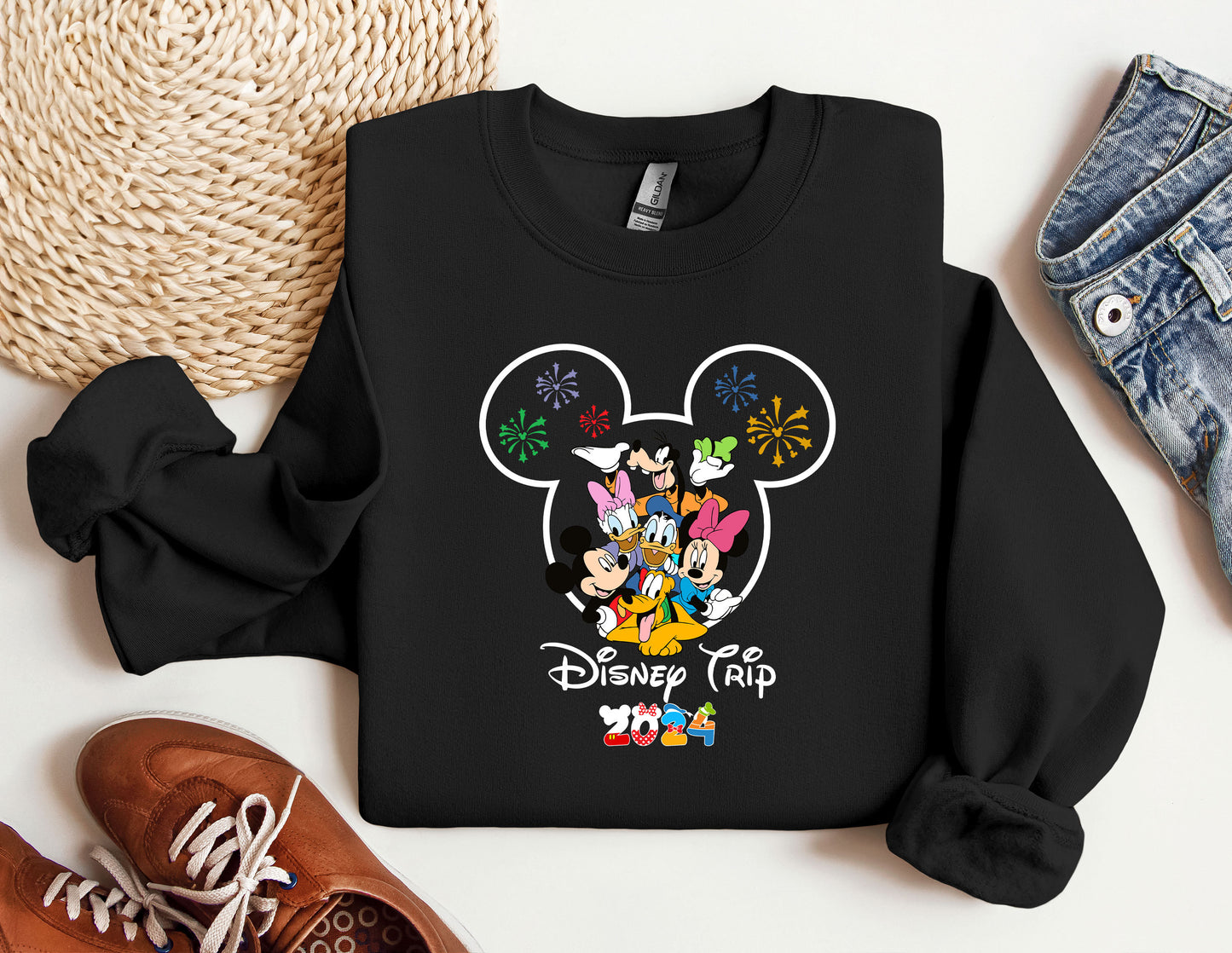 a mickey mouse shirt and some shoes on a table