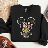 a mickey mouse shirt and some shoes on a table