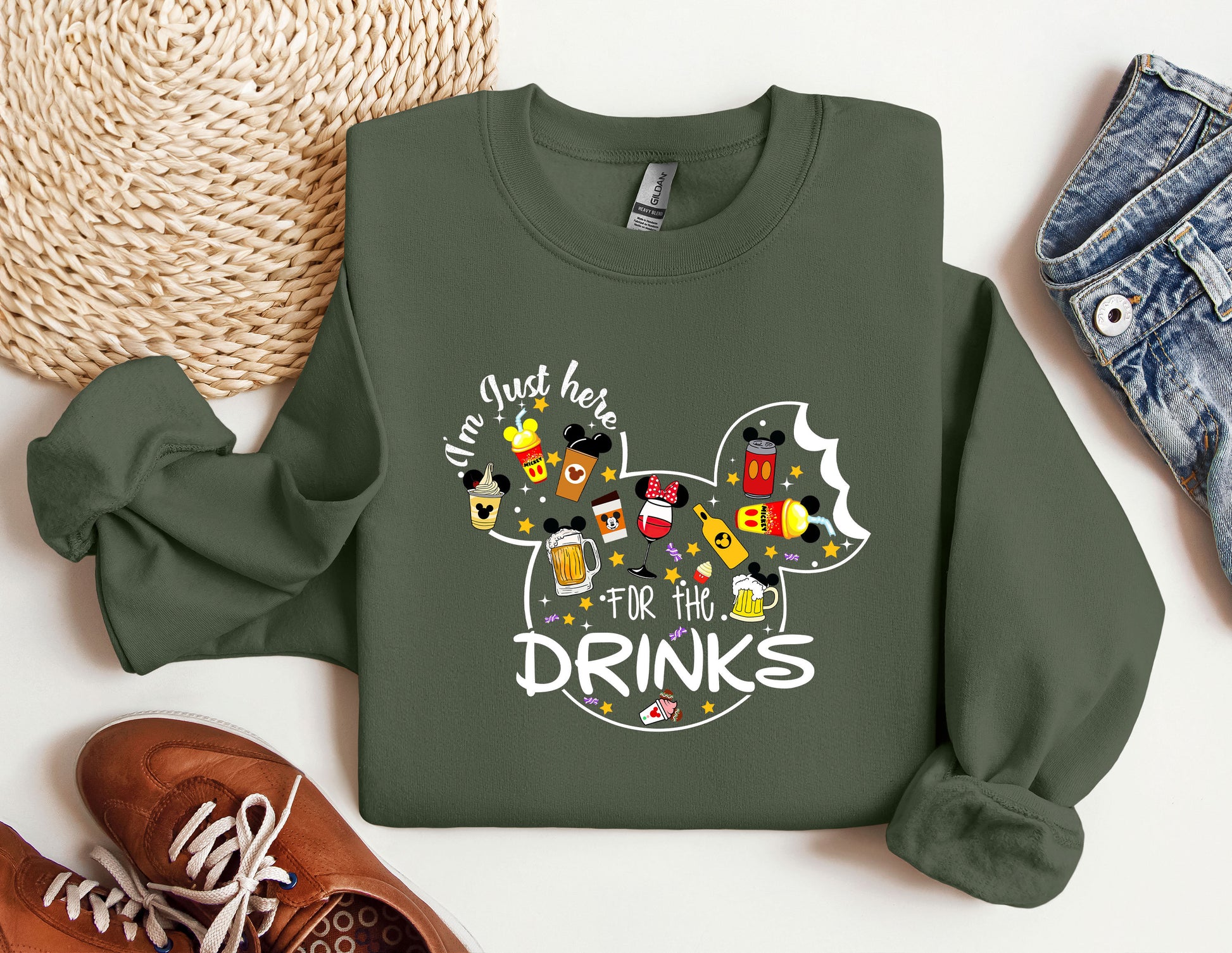 a green sweatshirt with a mickey mouse design on it