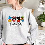 a woman sitting on a bed wearing a mickey mouse sweatshirt