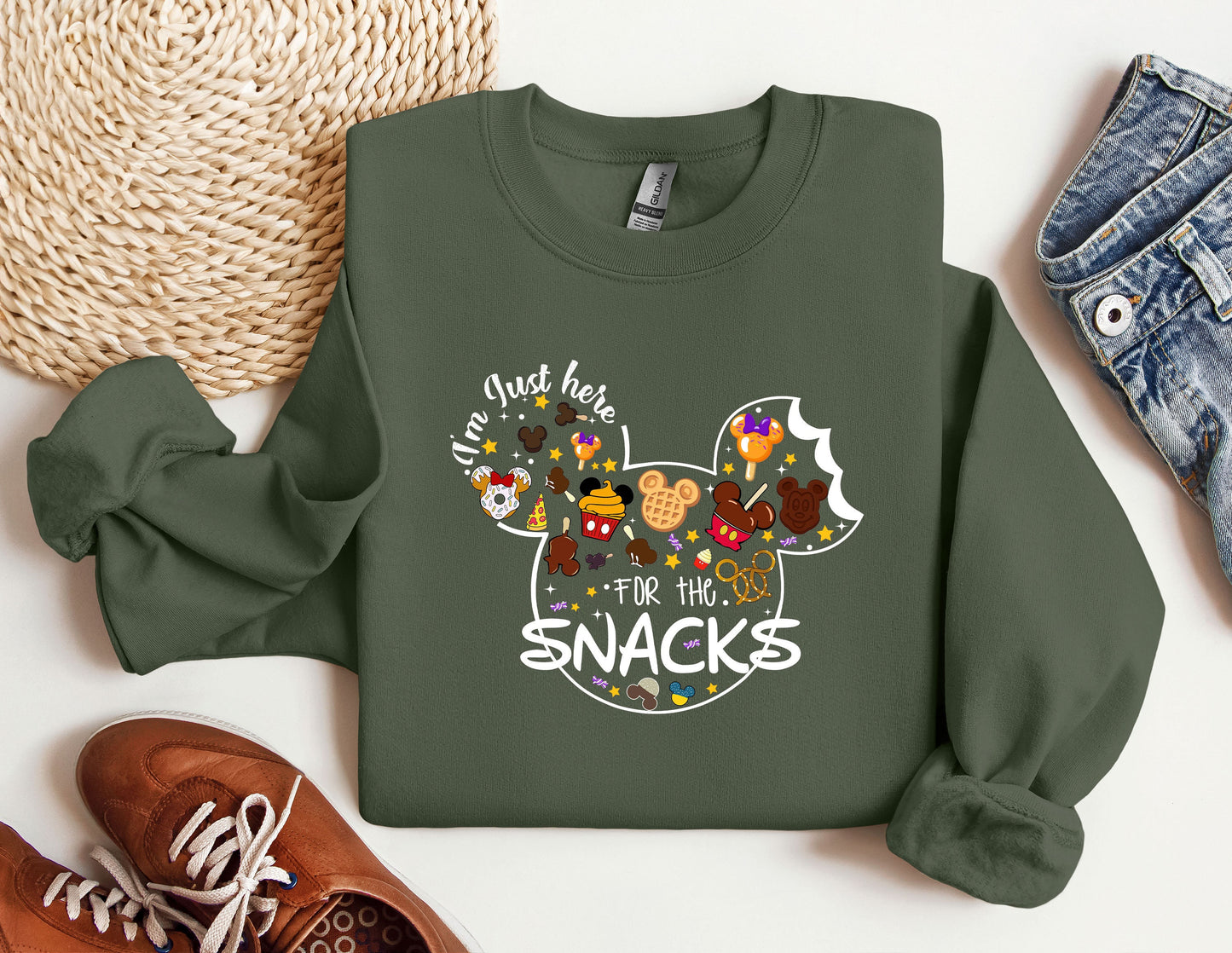 a green sweatshirt with mickey mouse and friends on it