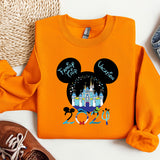 an orange shirt with a mickey mouse on it
