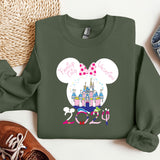 a green sweatshirt with a minnie mouse design on it