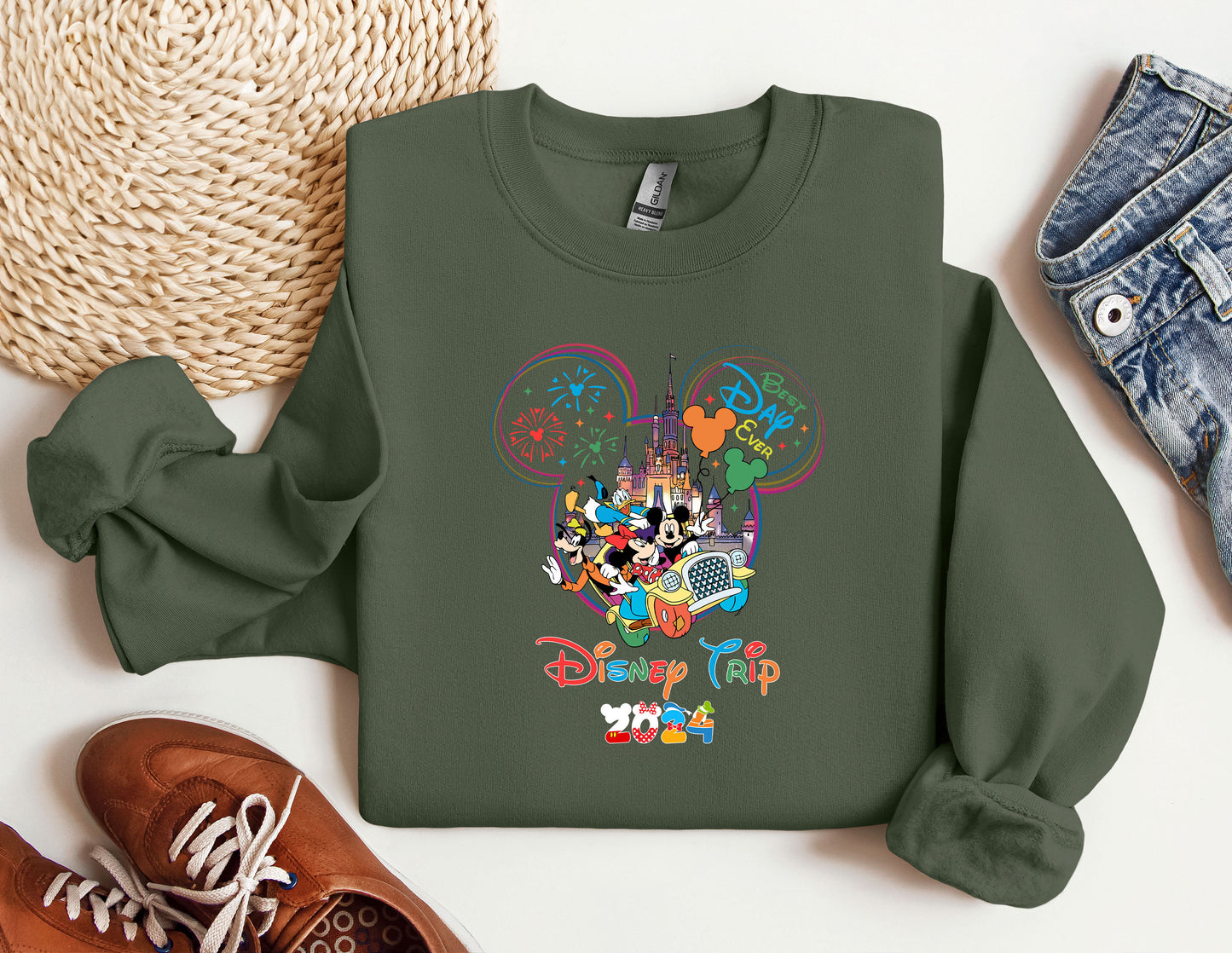 a green sweatshirt with mickey mouse on it