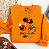 an orange shirt with mickey mouse on it