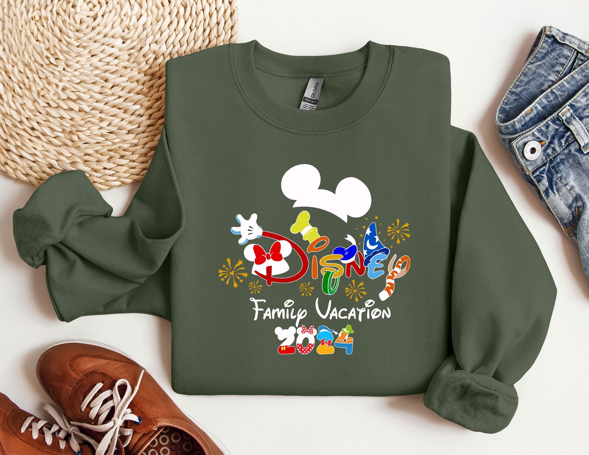 a mickey mouse family vacation sweatshirt next to a pair of sneakers