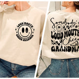 a woman wearing a sweatshirt with a smiley face on it