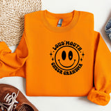 an orange sweatshirt with a smiley face on it