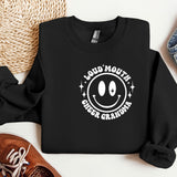a black sweatshirt with a smiley face on it