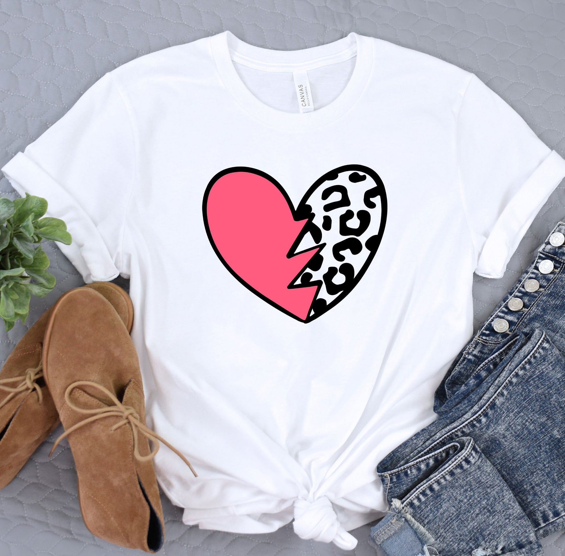 a white t - shirt with a pink heart and leopard print