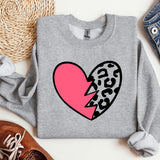 a grey sweater with a pink heart and a leopard print