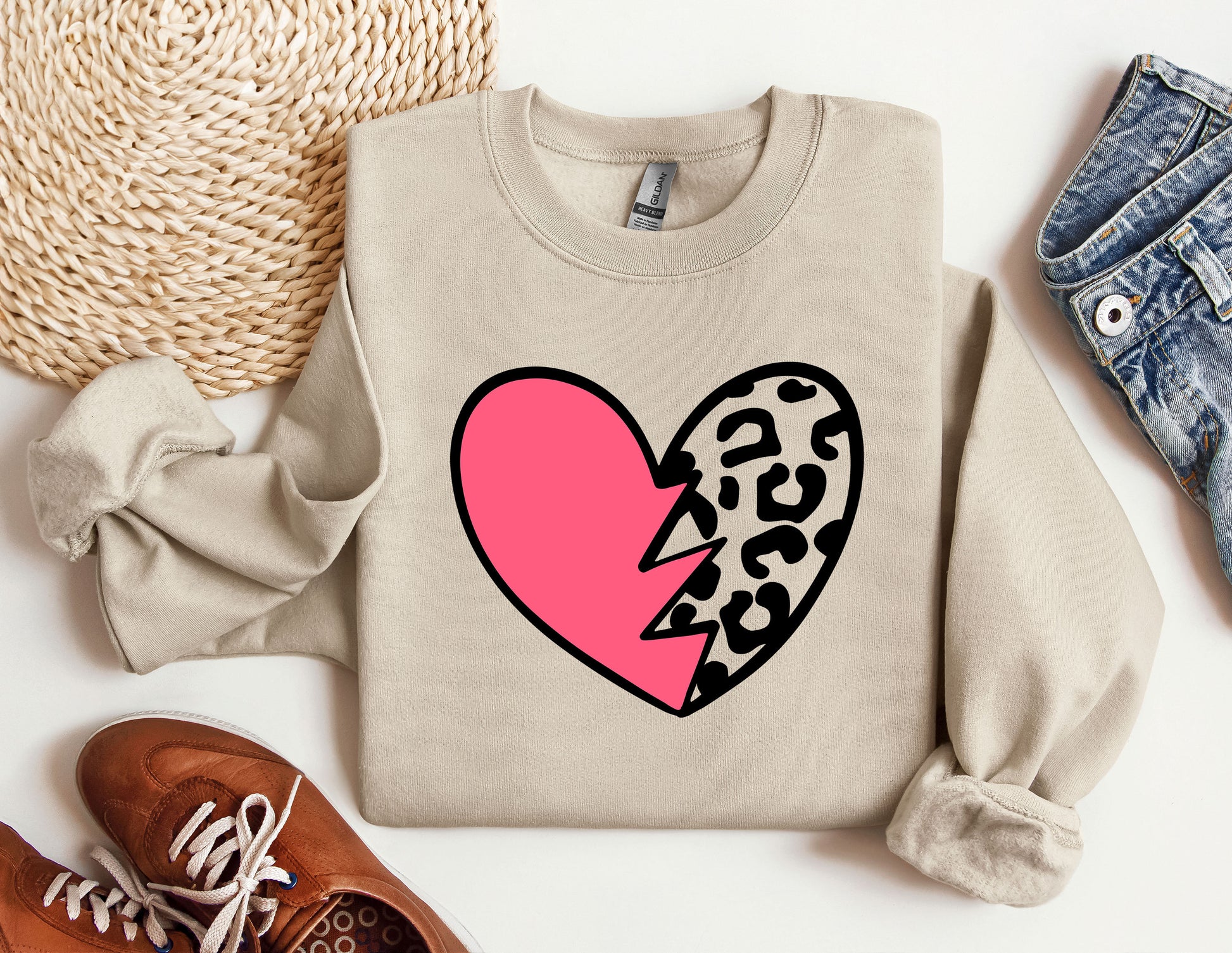 a sweater with a heart and a broken heart on it