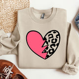 a sweater with a heart and a broken heart on it