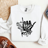a white sweatshirt with a black ink drawing of a peace sign
