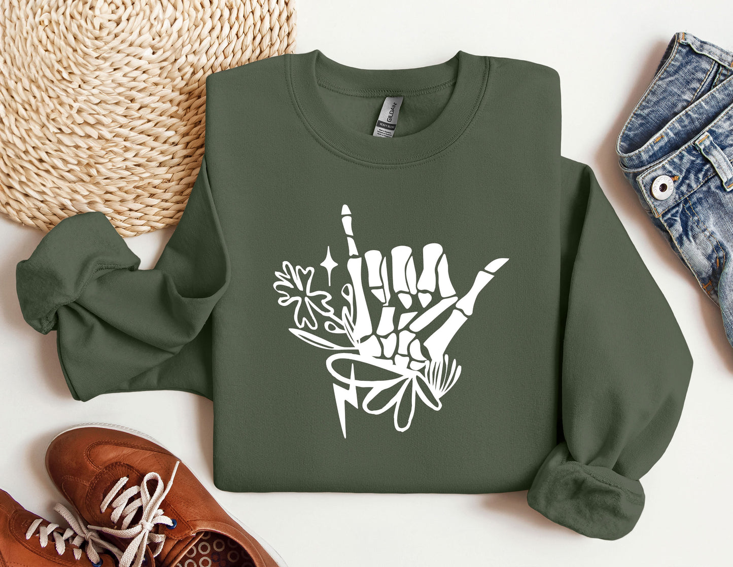 a green sweatshirt with white graffiti on it