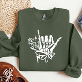 a green sweatshirt with white graffiti on it