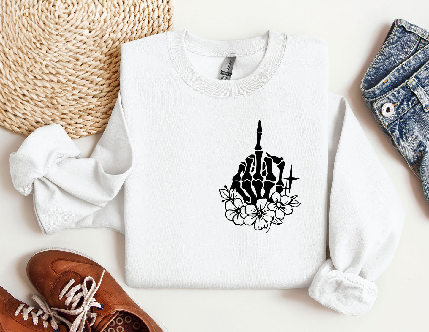 a white sweatshirt with a black graphic of a church and flowers