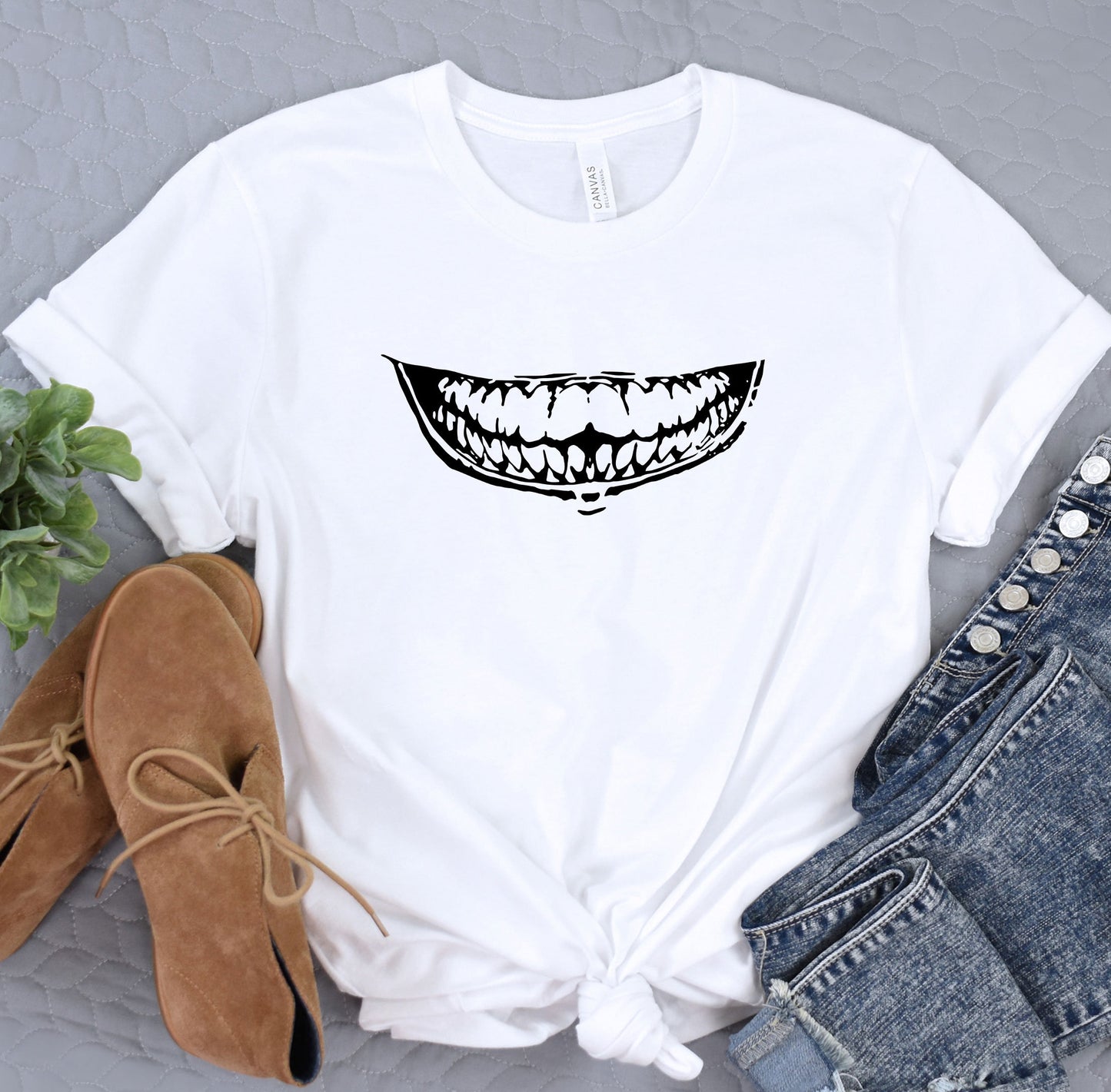 a white t - shirt with a smile drawn on it